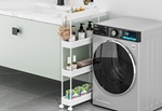 The SPACEKEEPER Laundry Room Storage Cart neatly slotted between a washing machine and a basin, showcasing its use of narrow space.